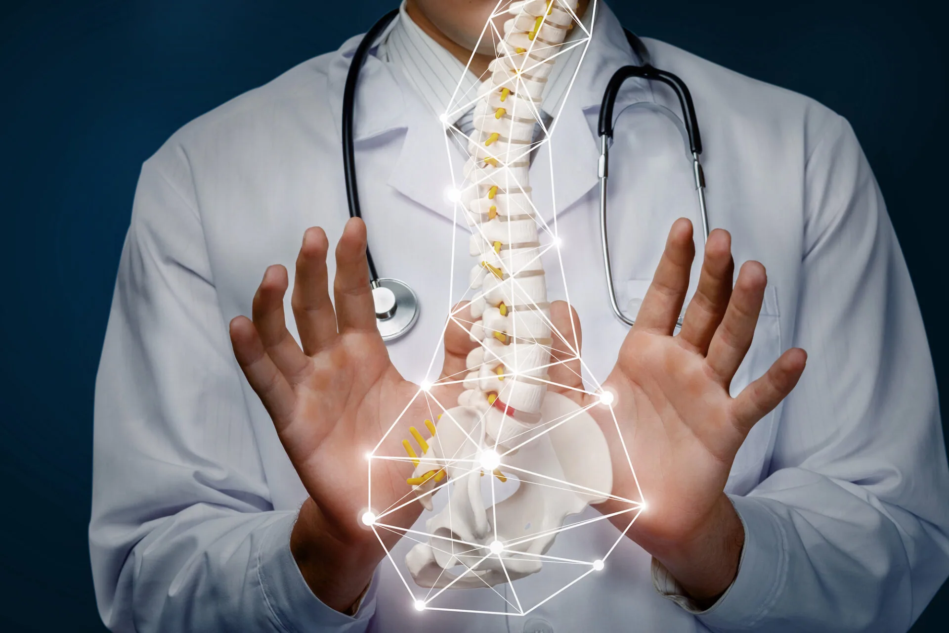 Doctor in white coat with stethoscope displaying illuminated spinal column visualization between hands